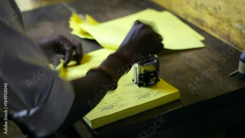 Thiruvanomalai, India – DEC, 2016: The Indian man stamping the forms.