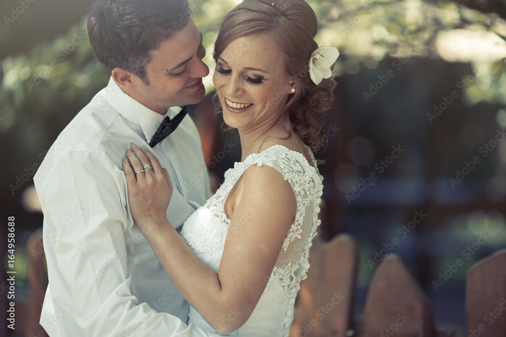 Beautiful bride and groom kissing outdoors