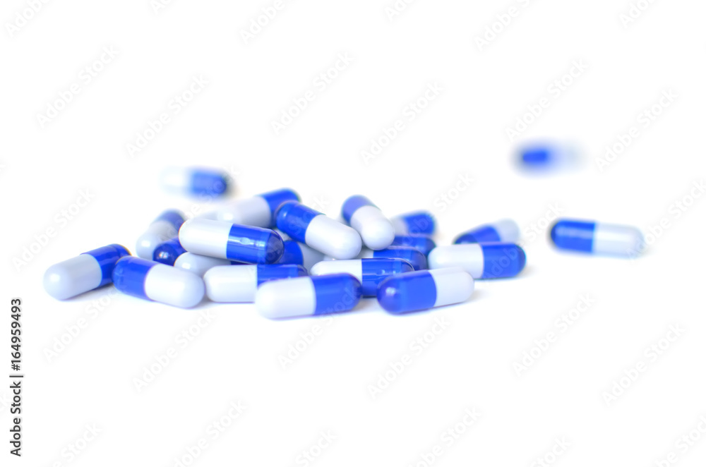 Blue pills on a white surface Blue pills on a white surface