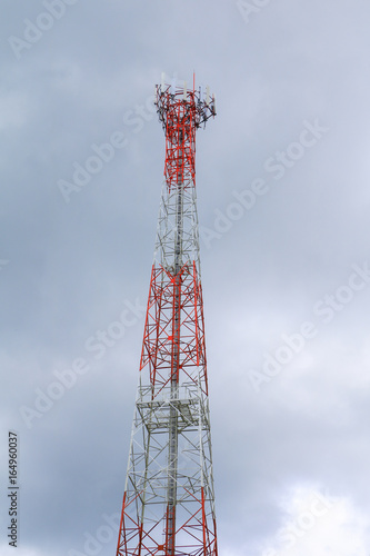 Telecommunication tower red and white antenna radio telephone mobile on sky background