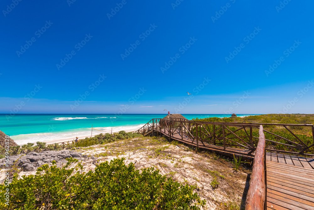Pathway to the sandy beach Playa Paradise of the island of Cayo Largo, Cuba. Copy space for text. Pathway to the sandy beach Playa Paradise of the island of Cayo Largo, Cuba. Copy space for text.