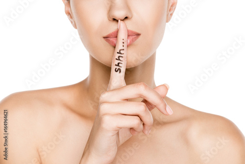 Quadro su tela cropped view of beautiful woman with shh symbol, isolated on white
