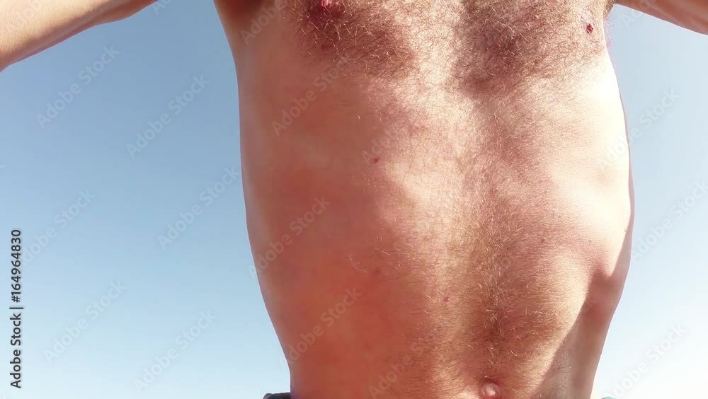 Belly and Torso of a Thin Male Yogi Trying to do a Yoga Exercise Close-Up Belly and Torso of a Thin Male Yogi Trying to do a Yoga Exercise Close-Up