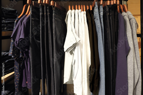 Clothes hanging on rack in shop.