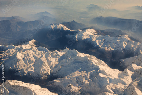 Aerial shot, Alps seen from the plane, Cinematic mountain landscape © alekosa