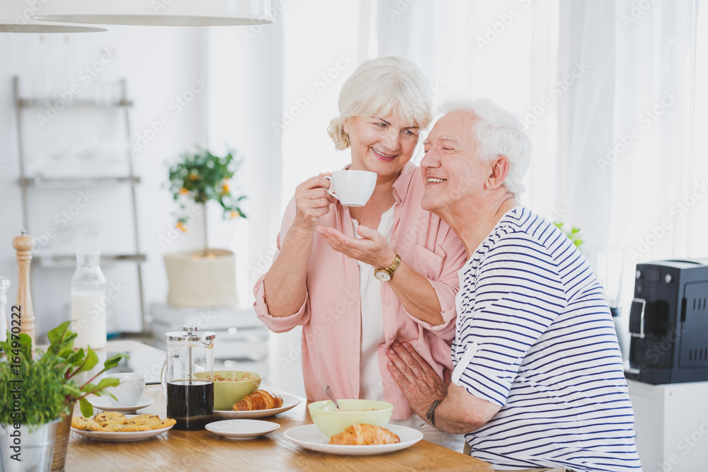 Elder man and his wife with a cup