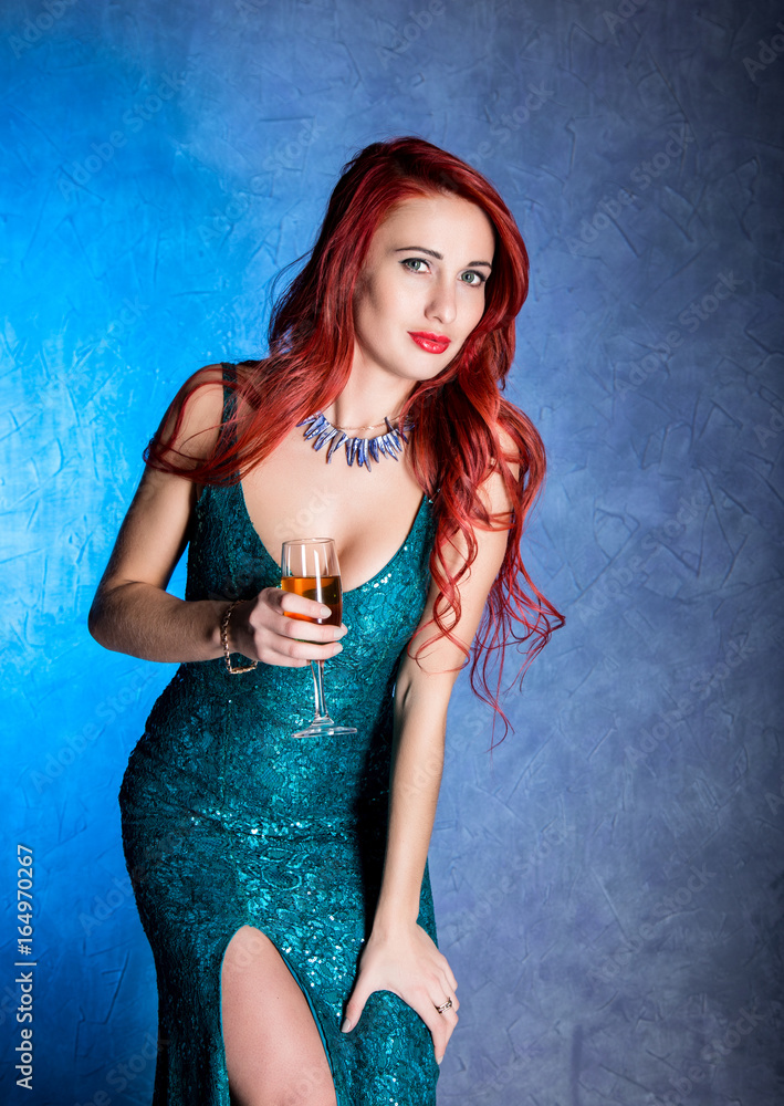 elegant sexy woman with big boobs in tight blue dress holding wineglass  with champagne Photos | Adobe Stock