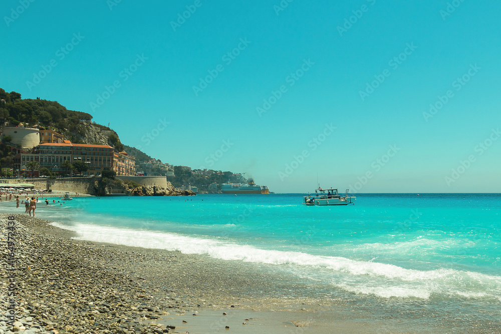 Obraz premium Crowded Mediterranean summer beach in City of Nice