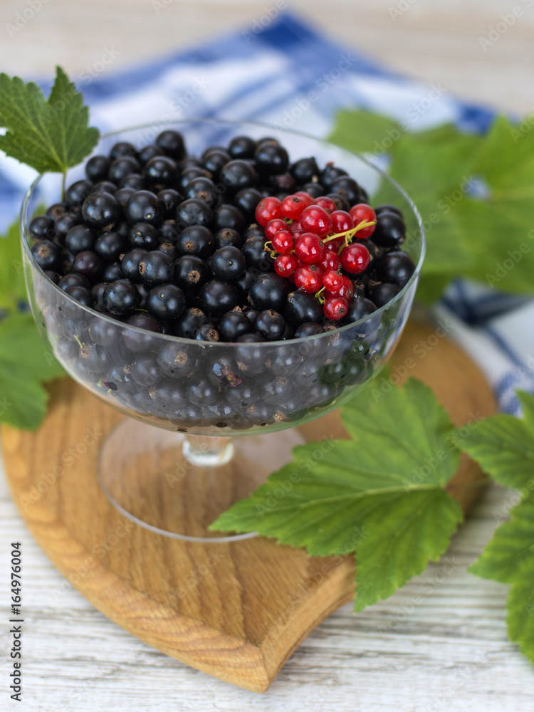 Berries of black currant in a glass plate. Berries of black currant in a glass plate.