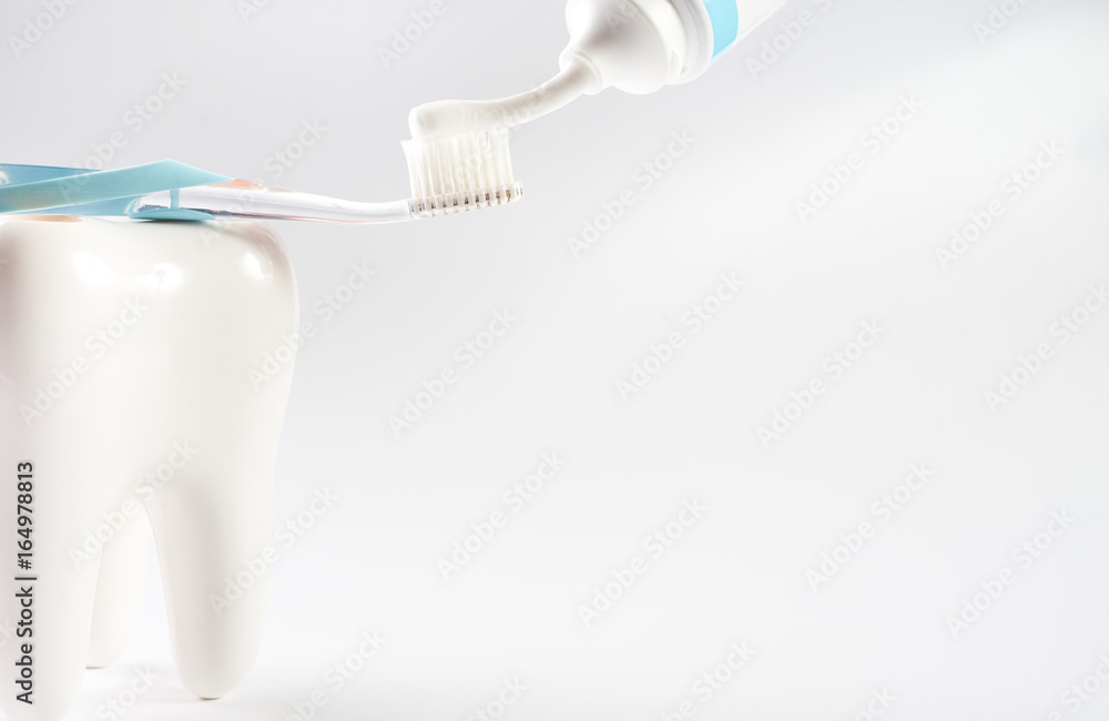 Modern toothbrush and toothpaste with white healthy enamel tooth model ...