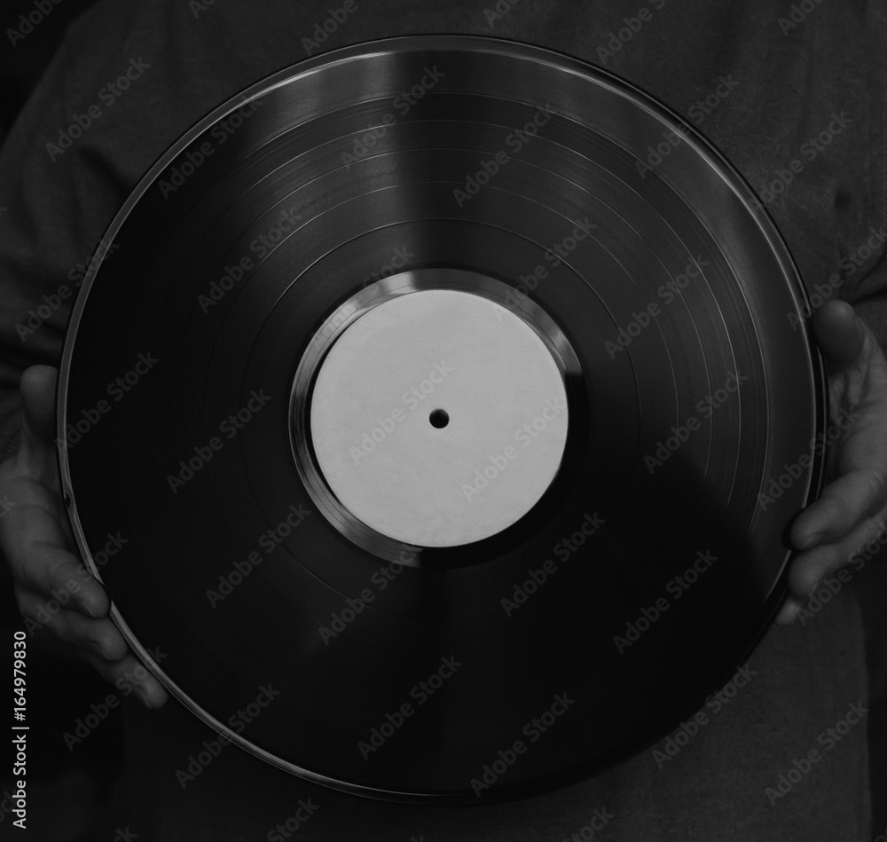 Obraz premium vinyl disk in hands. Close-up. Black and white.