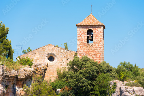 View of the Romanesque church of Santa Maria de Siurana  in Siurana de Prades  Tarragona  Catalunya  Spain. Copy space for text. Isolated on blue background.