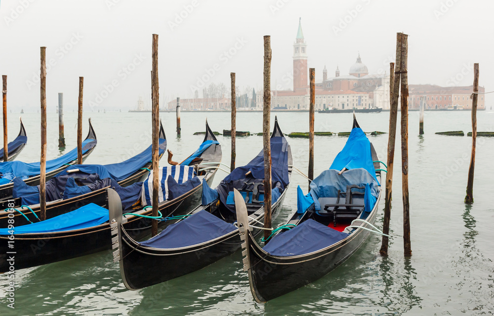 Gondola moored at dock in Venice.