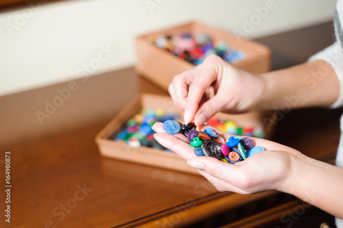 colorful sewing buttons in the hands