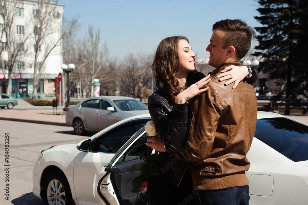 Young beautiful couple resting, walking in park, smiling, rejoicing. Outdoor background. Young beautiful couple resting, walking in park, smiling, rejoicing. Outdoor background.