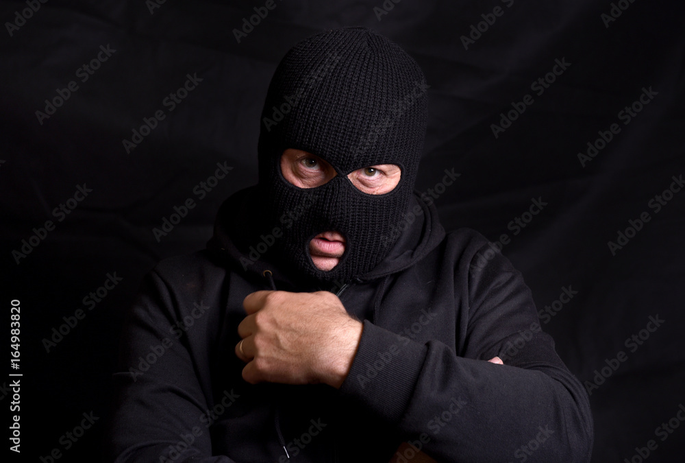 Horizontal image of a threatening man with a balaclava mask Horizontal image of a threatening man with a balaclava mask