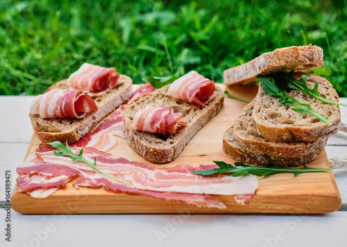 Bread with gourmet meat on a wooden desk.