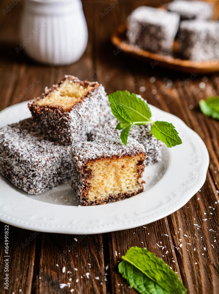 Lamington cakes with chocolate and coconut coating Lamington cakes with chocolate and coconut coating