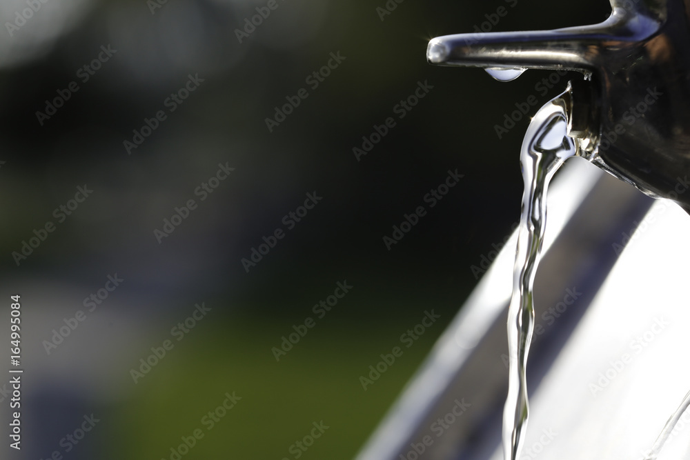 Water coming out of drinking fountain Water coming out of drinking fountain