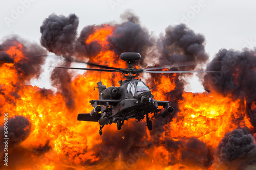 Army Air Corps WAH-64D Apache in front of a wall of fire