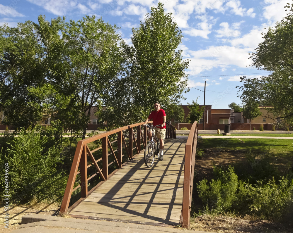 Fototapeta premium A Cyclist Rides the Santa Fe River Trail