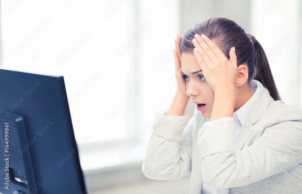 stressed student with computer in office stressed student with computer in office