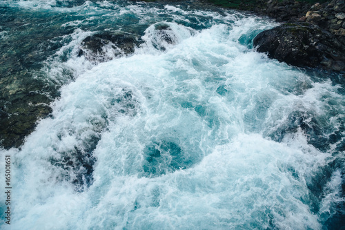 Waterfall from mountain deep forest. Rushing water from a waterfall, the swirling of water, a funnel, a blurred background