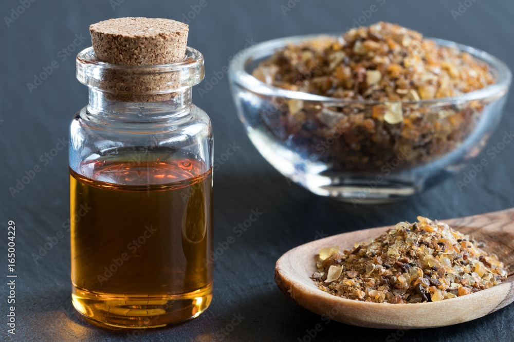 A bottle of myrrh essential oil with myrrh resin A bottle of myrrh essential oil with myrrh resin