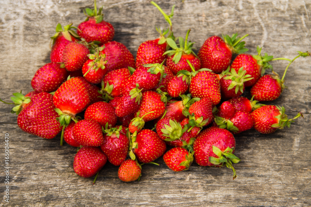 Ripe fresh strawberries on rustic wooden background. Top view