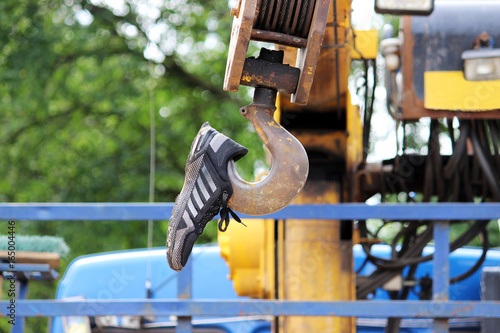 Protective cover on the hook from the lifting crane, built into the truck in the form of a sneaker photo