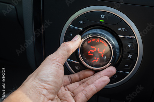 Adjust air conditioner in car , Driver hand tuning temperature control in car air conditioning system