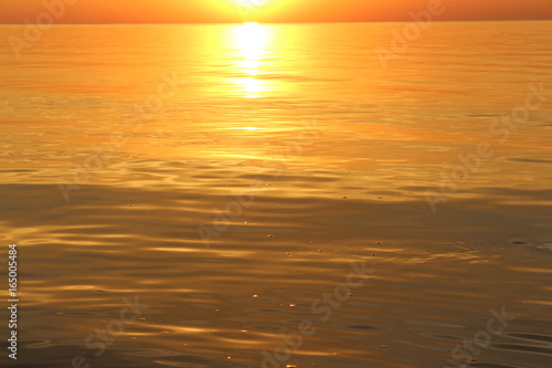 Golden water in the sea at sunset