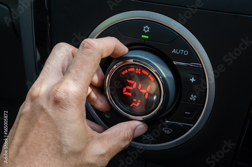 Adjust air conditioner in car , Driver hand tuning temperature control in car air conditioning system