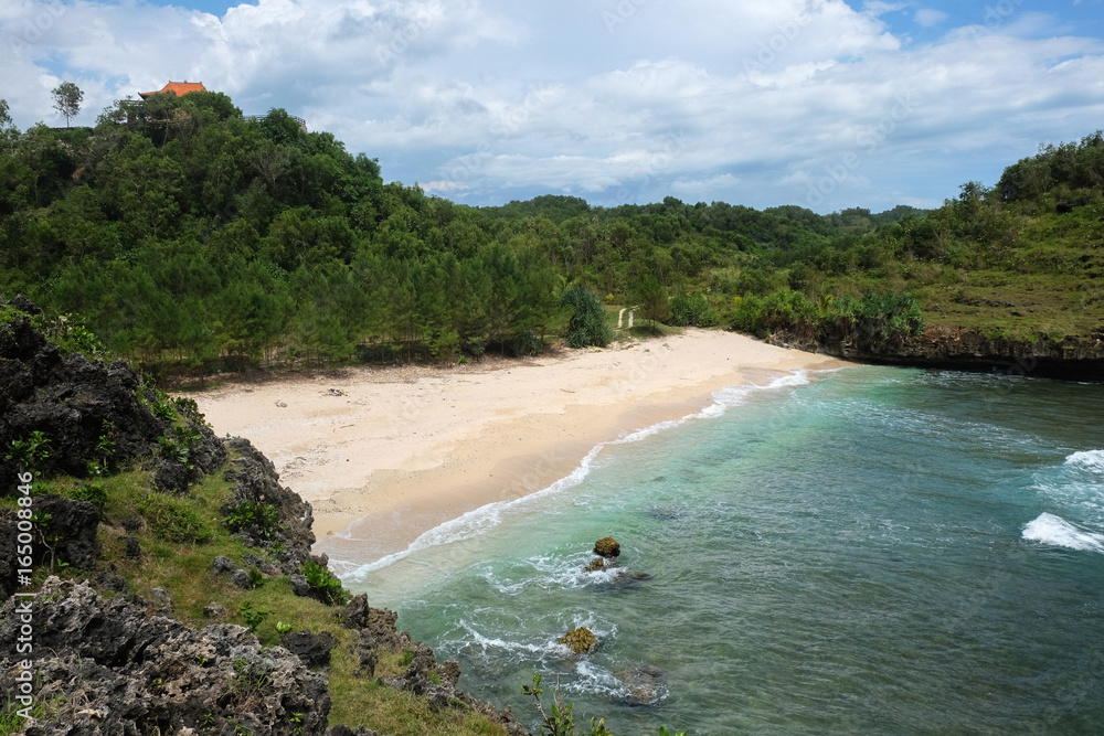 perfect destination for vacation - small tropical bay with bright sand, and a house on hill