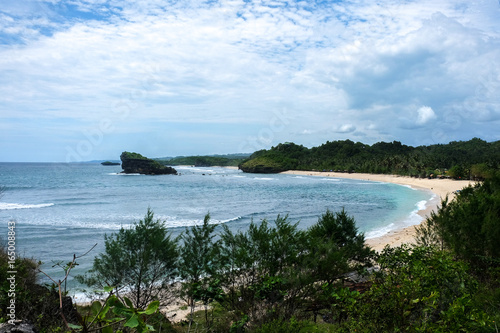 perfect vacation - tropical bay with white sand and perfect waves for surfing close to Pacitan beach