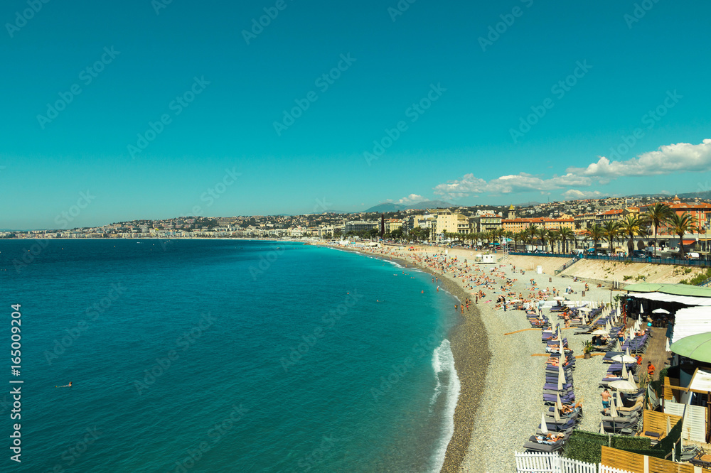 Crowded Mediterranean summer beach in City of Nice