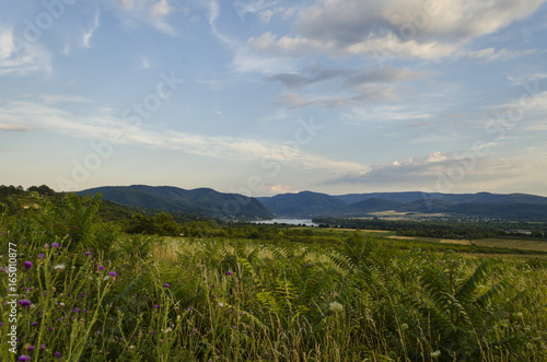 river in distance scenic summer green landscape of hills 