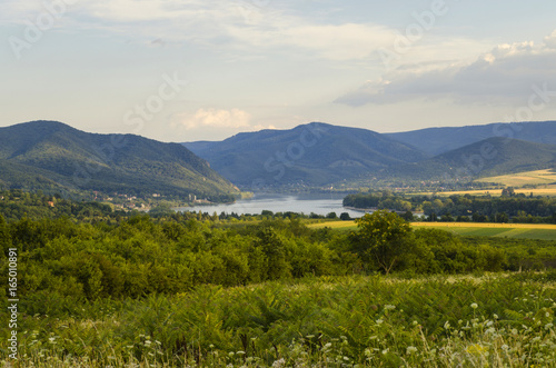 river in distance scenic summer green landscape of hills 