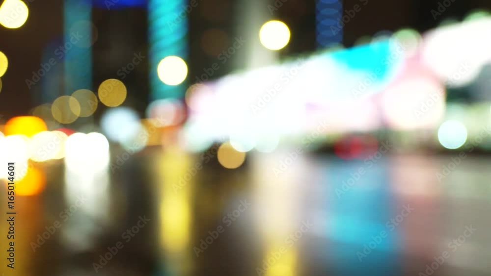 Blurred lights from moving cars, on the street after rain, home with glowing windows and advertising, out of focus. Blurred lights from moving cars, on the street after rain, home with glowing windows and advertising, out of focus.