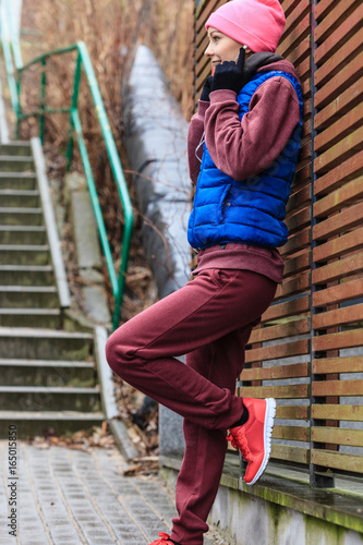 Woman wearing warm sportswear relaxing after exercising