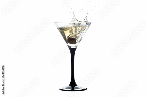 Cocktail martini with olive, a splash of vermouth in a glass