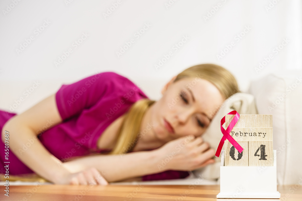 Woman on bed, world breast cancer day on calendar Woman on bed, world breast cancer day on calendar