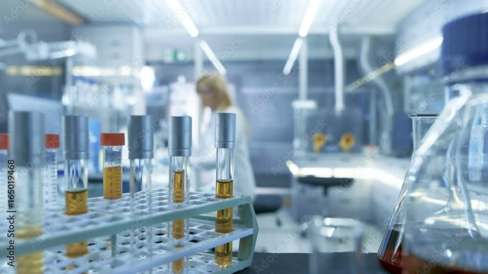 Point of View Shot of a Moving Cart with Test-Tubes, Analysis, Beakers and Various Glassware. Scientist Takes Some of Test-Tubes for Herself. Shot on RED EPIC-W 8K Helium Cinema Camera. Point of View Shot of a Moving Cart with Test-Tubes, Analysis, Beakers and Various Glassware. Scientist Takes Some of Test-Tubes for Herself. Shot on RED EPIC-W 8K Helium Cinema Camera.