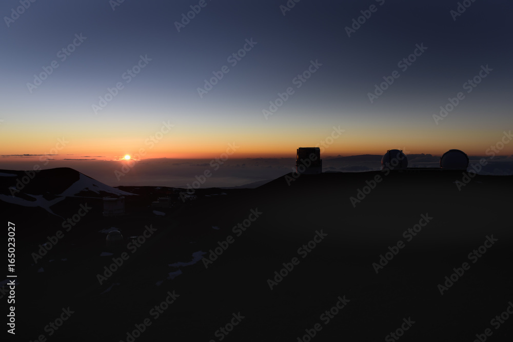 The sunset and the observatory group of the mountain top of Maunakea The sunset and the observatory group of the mountain top of Maunakea