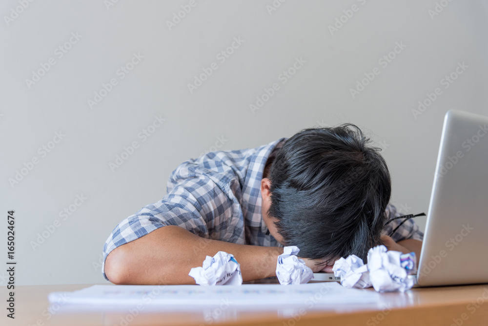 Hard think on the analysis in the work. Young Asian business man is working on pressure in the bright office. Hard think on the analysis in the work. Young Asian business man is working on pressure in the bright office.