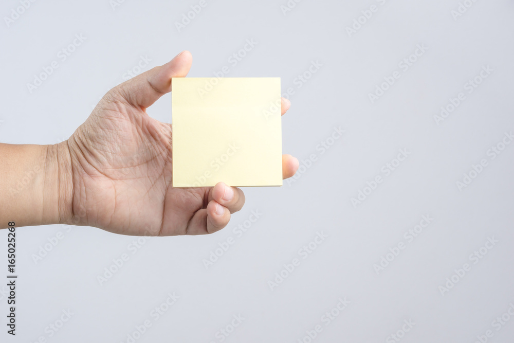 Obraz premium Hand holding sticky post note paper sheet