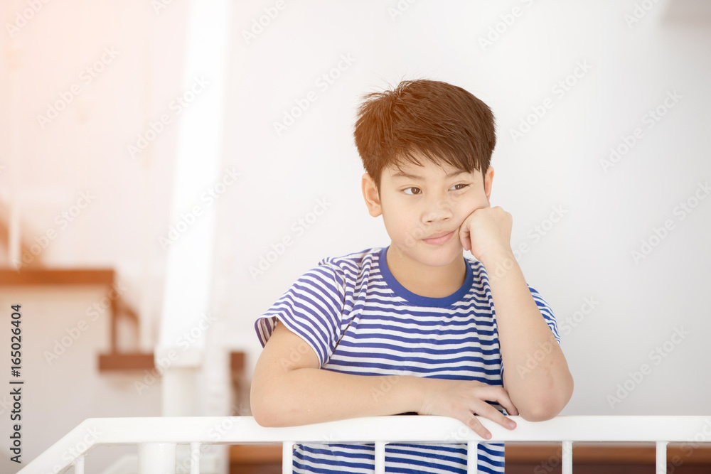 Little asian boy, lost in thoughts, and sad Little asian boy, lost in thoughts, and sad