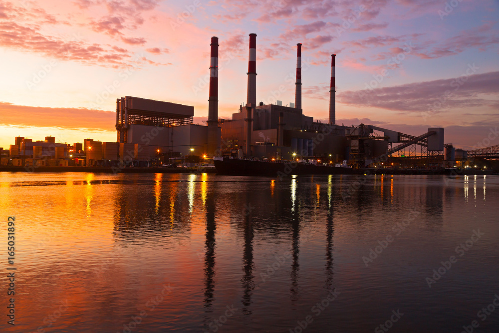 Electric Power plant at sunrise. New York city infrastructure on the shore of East River at dawn.