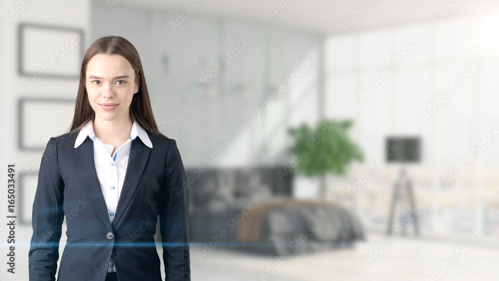 Young beautiful business woman and creative designer standing over blured interior background Young beautiful business woman and creative designer standing over blured interior background
