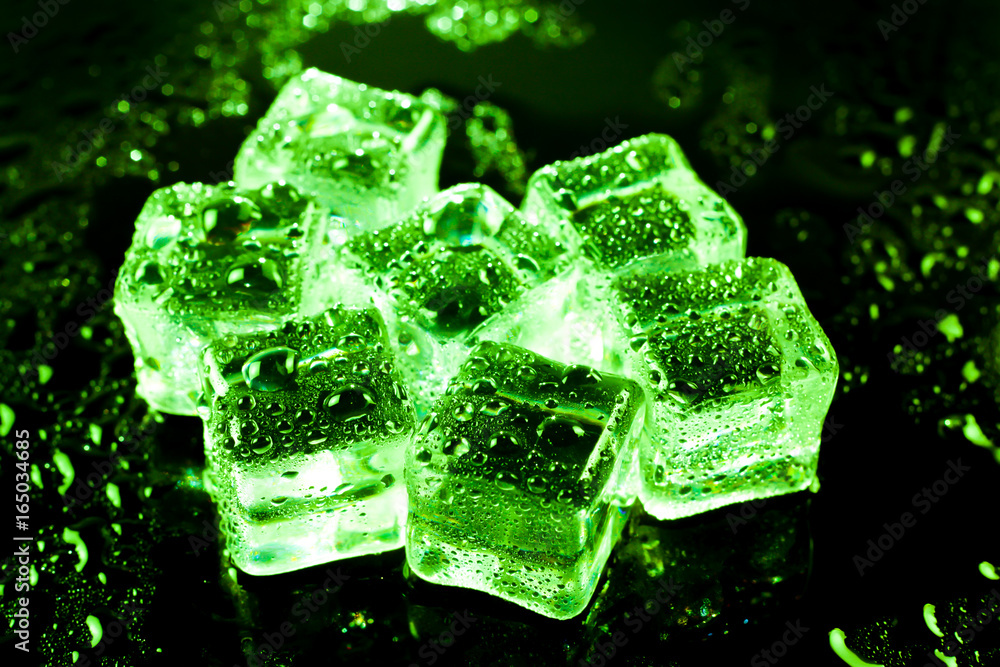 Green ice cubes on black wet table. Green ice cubes on black wet table.
